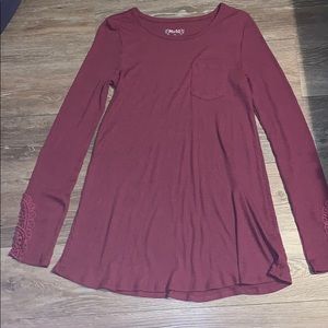 A maroon long sleeve tee shirt